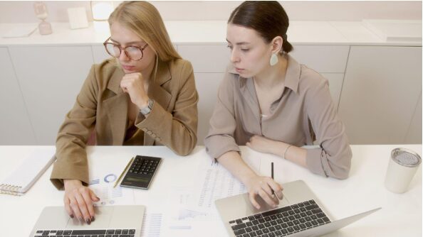 Screenshot-2026-09-02-160247.png two women with laptops