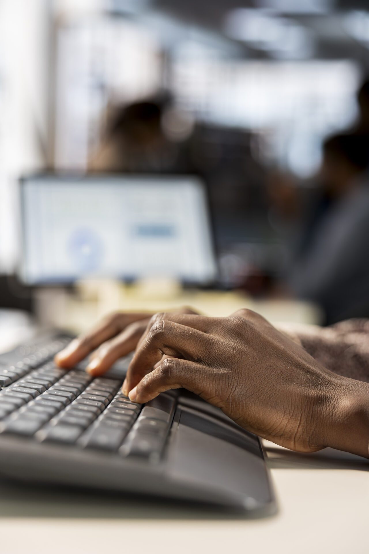 hands typing on computer